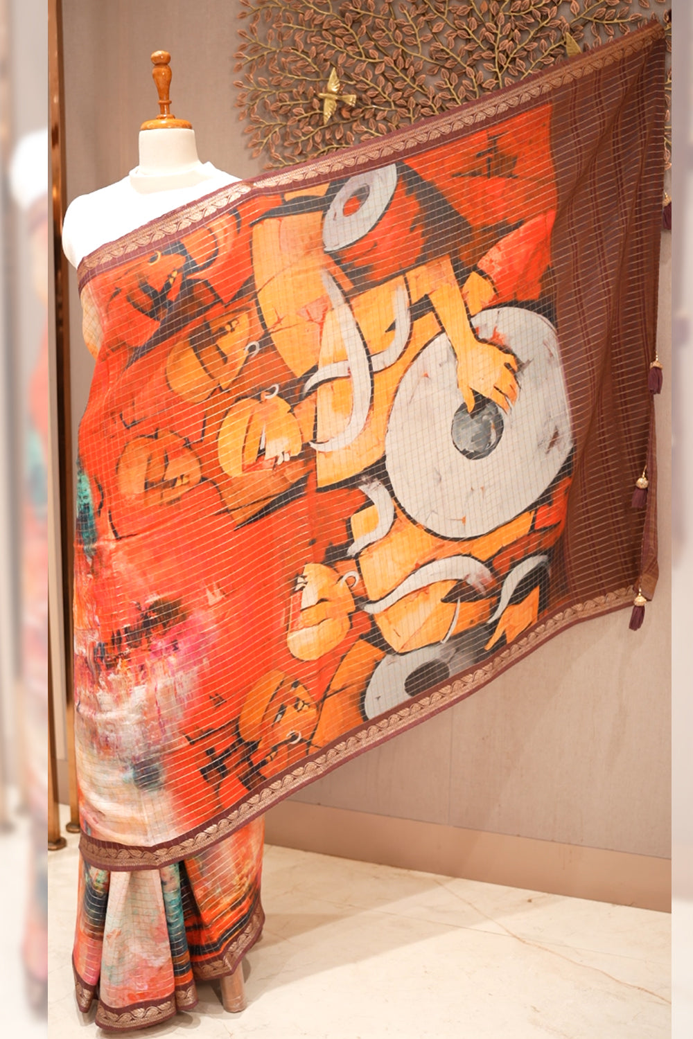 Orange chiffon Dola silk saree featuring a soft, flowy drape and subtle sheen, perfect for festive events and graceful occasions.